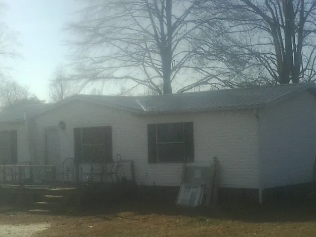 New metal roof on a white painted brick home on a foggy morning in Enon Valley