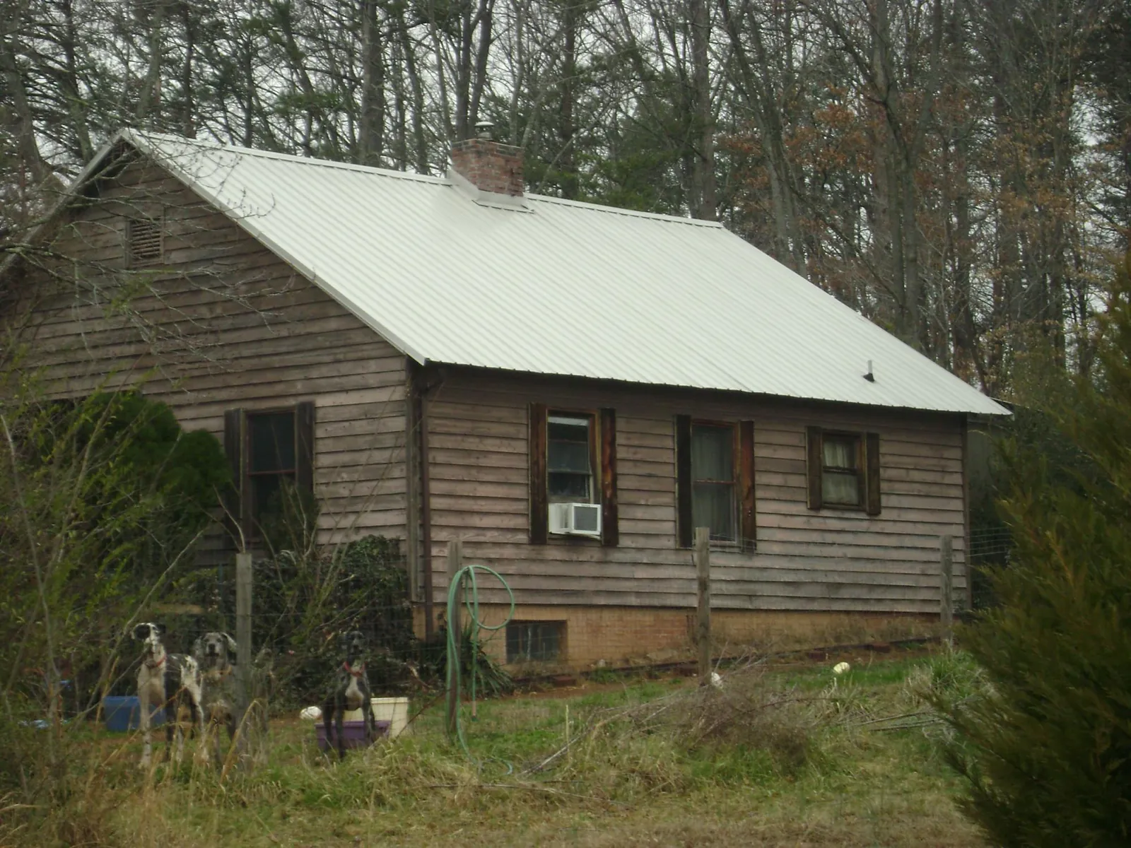 White metal roof on an old wood sided farmhouse, from a Asphalt Shingle Roof Repair job in Enon Valley
